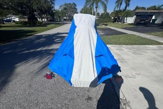 Slide: The Image of 2018 Yamaha WaveRunner EX Deluxe covered with blue and white tarp on driveway. - 35