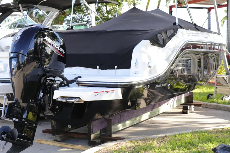 Slide: The Image of 2022 Bayliner DX 2200 boat with Mercury outboard engine, covered and docked. - 0
