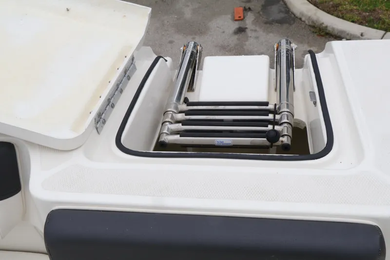 Slide: The Image of Bayliner DX 2200 2022 boat ladder compartment, featuring stainless steel retractable steps. - 13