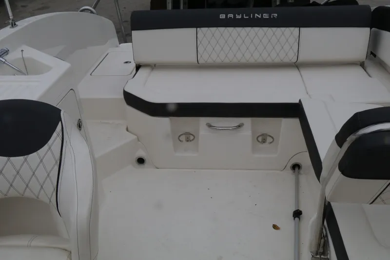 Slide: The Image of 2022 Bayliner DX 2200 boat interior with white seating and diamond stitching. - 15