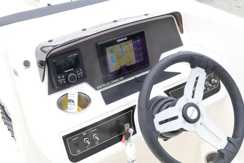 Slide: The Image of 2022 Bayliner DX 2200 dashboard with steering wheel, navigation display, and control panel. - 5