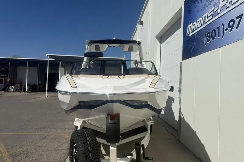 Slide: The Image of 2025 Supra SV 575 boat on trailer outside Marine Pro shop. - 4