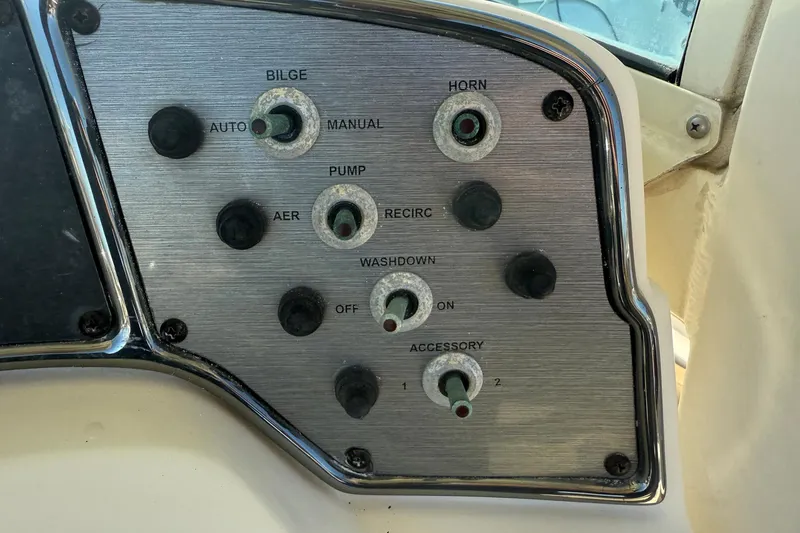 Slide: The Image of Control panel of a 2012 Scout 240 Bay Scout boat with various switches. - 19