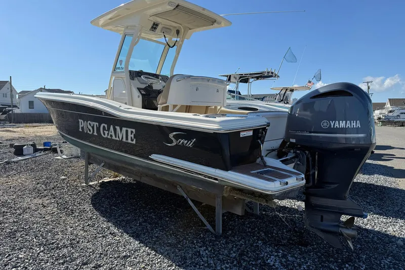 Slide: The Image of 2012 Scout 240 Bay Scout boat with Yamaha engine on gravel lot. - 2