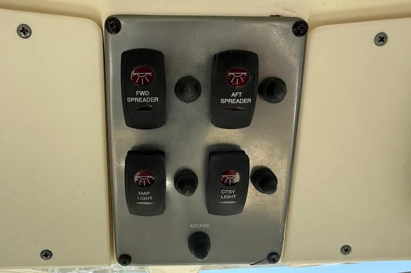 Slide: The Image of Control panel of a 2012 Scout 240 Bay Scout boat with light switches. - 20