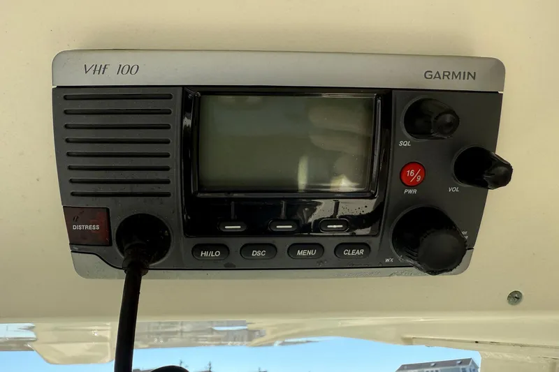 Slide: The Image of Garmin VHF 100 radio on 2012 Scout 240 Bay Scout boat dashboard. - 21