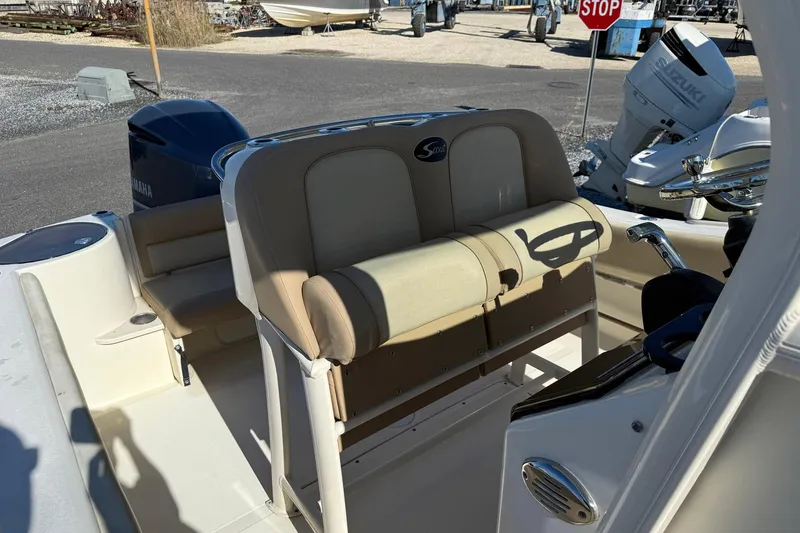 Slide: The Image of 2012 Scout 240 Bay Scout boat interior with Yamaha engine, beige seating, and steering wheel. - 24