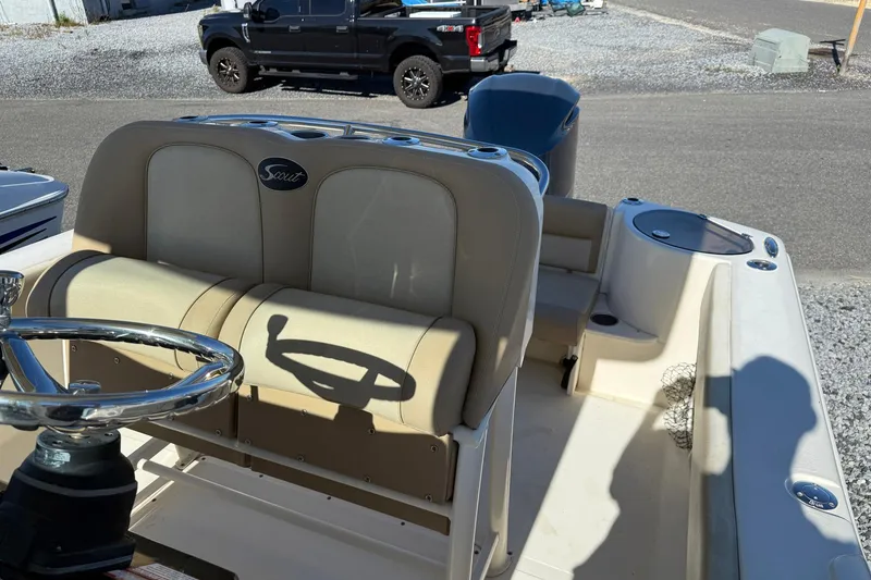 Slide: The Image of 2012 Scout 240 Bay Scout boat interior with steering wheel and seating. - 25