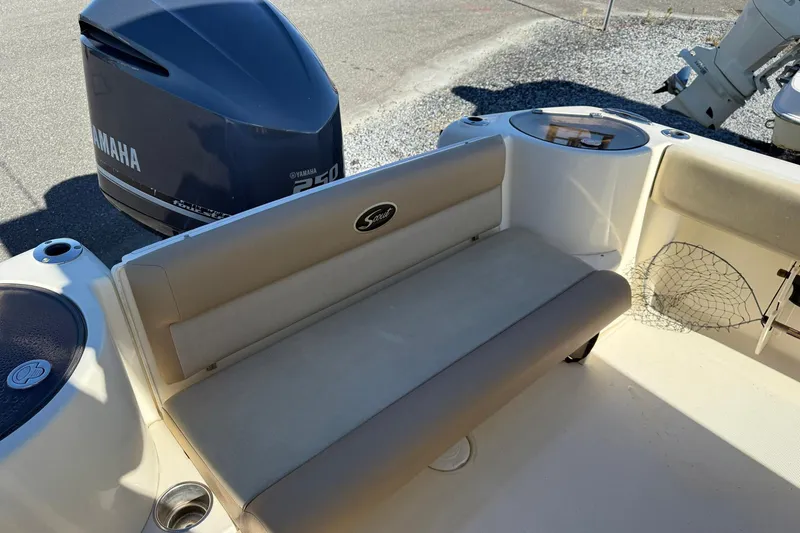 Slide: The Image of 2012 Scout 240 Bay Scout boat interior with Yamaha 250 engine, featuring seating and storage. - 27