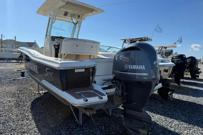 Slide: The Image of 2012 Scout 240 Bay Scout boat with Yamaha outboard motor on gravel lot. - 31