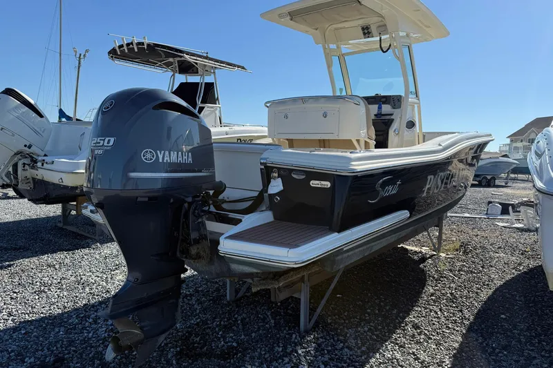 Slide: The Image of 2012 Scout 240 Bay Scout boat with Yamaha 250 V6 engine, parked on gravel. - 32
