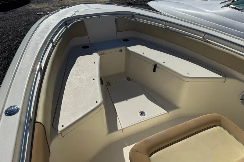 Slide: The Image of 2012 Scout 240 Bay Scout boat interior with seating and storage compartments. - 6