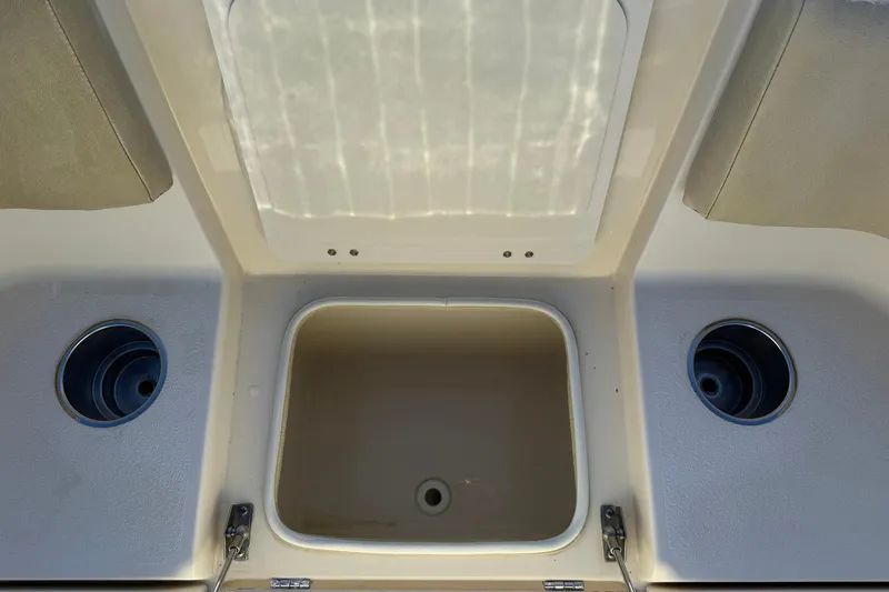 Slide: The Image of 2012 Scout 240 Bay Scout boat interior with storage compartments and cup holders. - 7