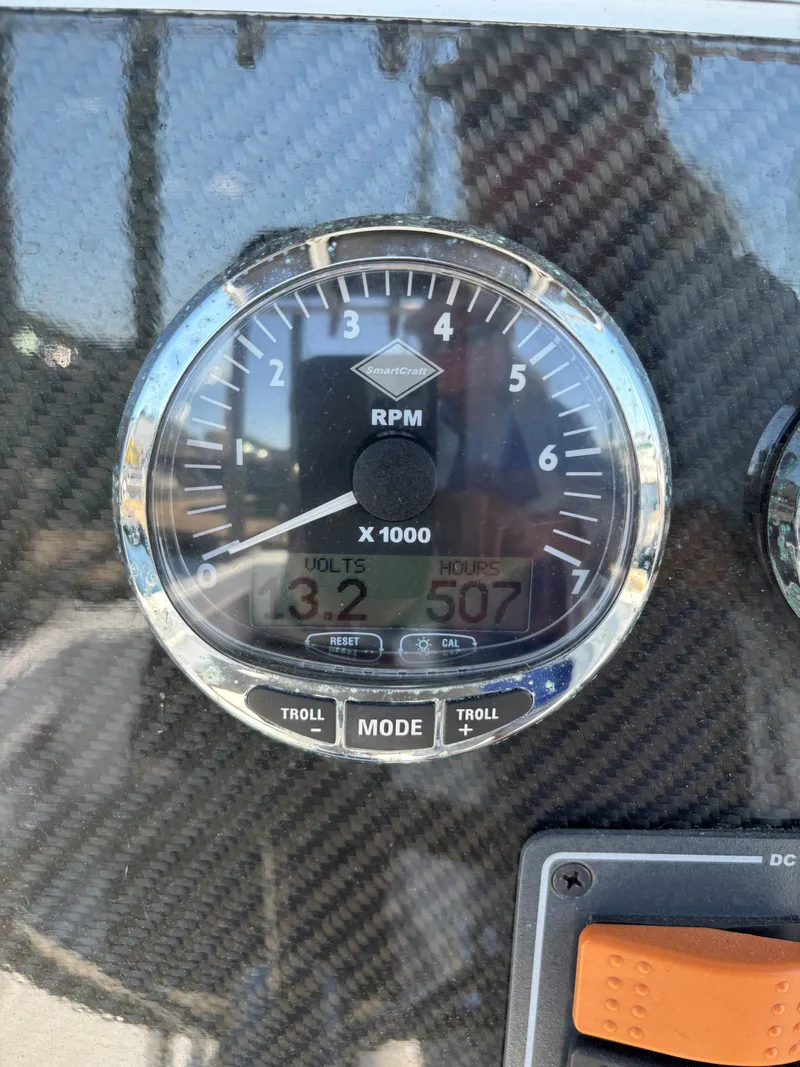 Slide: The Image of Close-up of a SeaCraft 23 Center Console 1988 RPM gauge displaying 3.2 volts and 507 hours. - 12