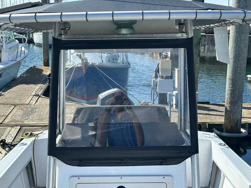 Slide: The Image of 1988 SeaCraft 23 Center Console boat docked at marina, front view. - 16
