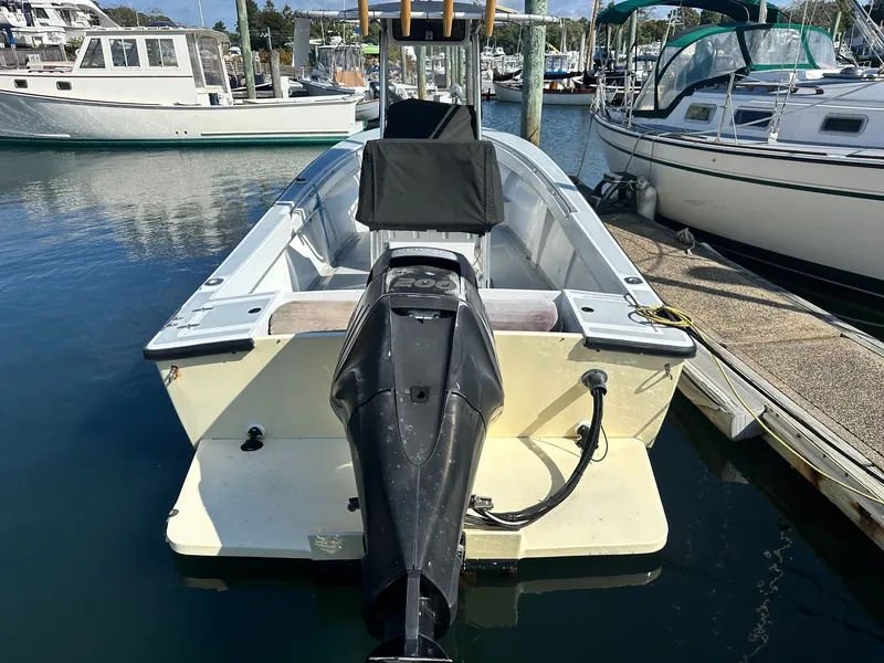Slide: The Image of 1988 SeaCraft 23 Center Console boat docked at marina, rear view. - 7