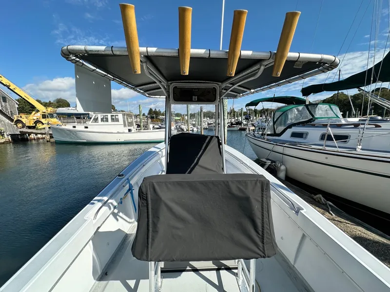Slide: The Image of 1988 SeaCraft 23 Center Console boat docked at marina, clear sky, surrounding sailboats. - 8