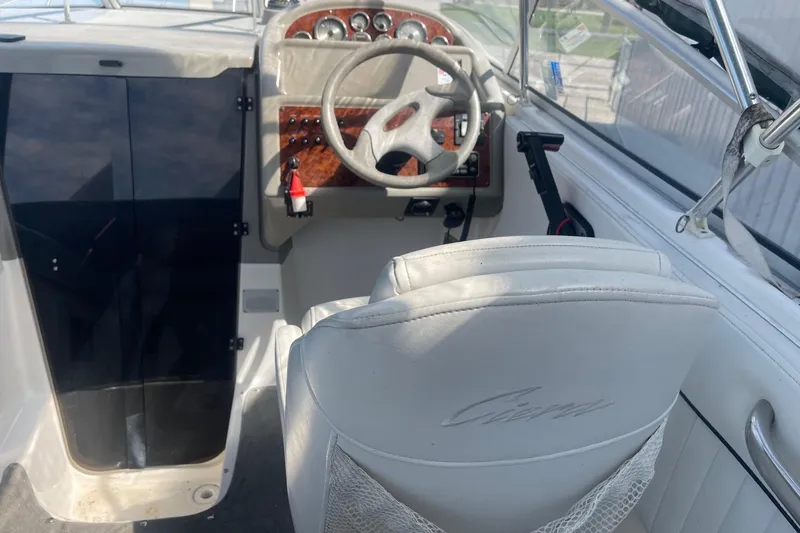 Slide: The Image of 1997 Bayliner 2655 Ciera cockpit with steering wheel and control panel. - 10