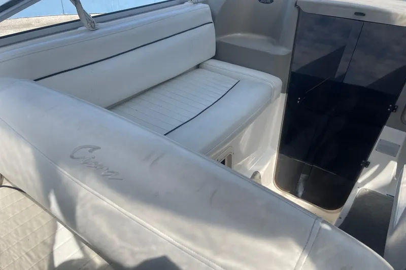 Slide: The Image of 1997 Bayliner 2655 Ciera boat interior with white seating and cabin entrance. - 11