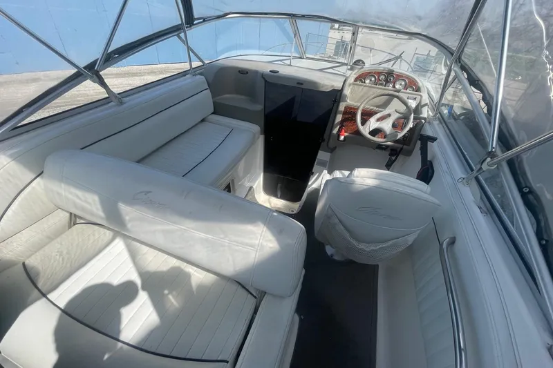 Slide: The Image of 1997 Bayliner 2655 Ciera boat interior with white seating and steering wheel. - 13