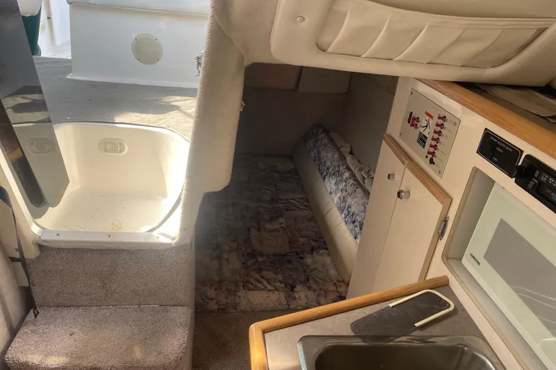 Slide: The Image of 1997 Bayliner 2655 Ciera cabin interior with kitchenette, seating, and control panel. - 24