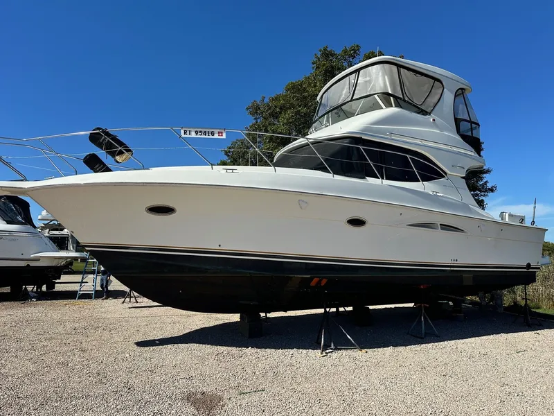 The Image of 2004 Silverton 38 Convertible yacht on stands, clear blue sky background. - 0