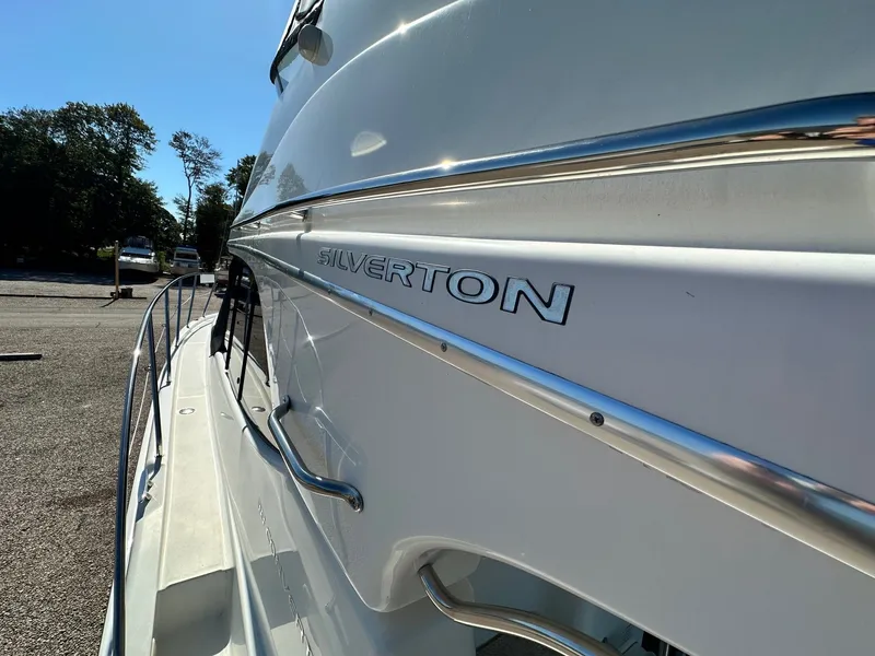 Slide: The Image of 2004 Silverton 38 Convertible yacht side view with logo and railing. - 12