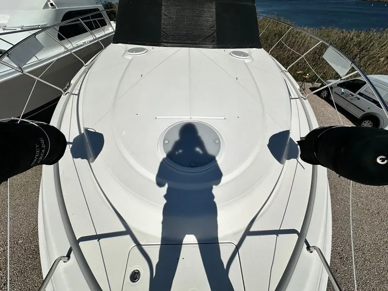 Slide: The Image of 2004 Silverton 38 Convertible yacht deck with shadow, docked near water. - 15