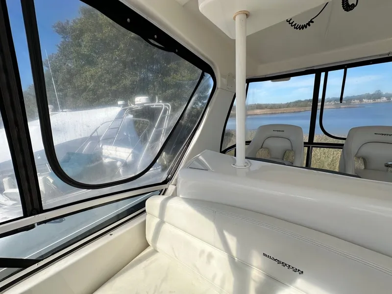 Slide: The Image of Interior view of 2004 Silverton 38 Convertible yacht with scenic water backdrop. - 21