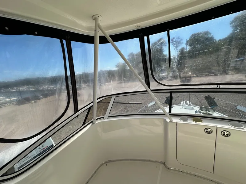 Slide: The Image of Interior view of 2004 Silverton 38 Convertible boat with clear windows and outdoor scenery. - 25