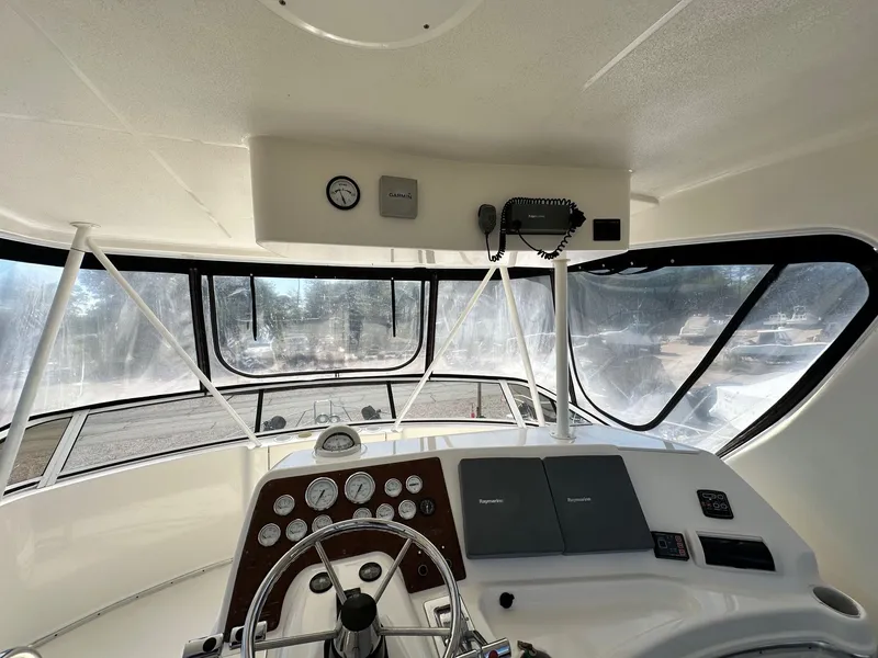 Slide: The Image of 2004 Silverton 38 Convertible boat helm with steering wheel and navigation instruments. - 28