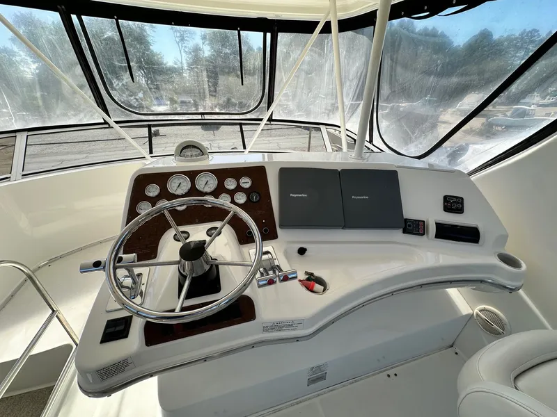 Slide: The Image of Helm of 2004 Silverton 38 Convertible yacht with steering wheel and navigation instruments. - 29