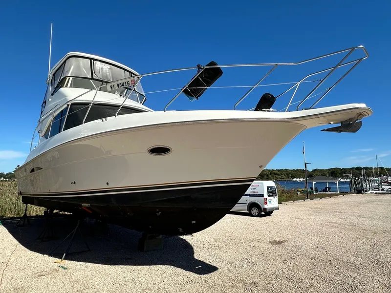 Slide: The Image of 2004 Silverton 38 Convertible yacht on dry dock under clear blue sky. - 3