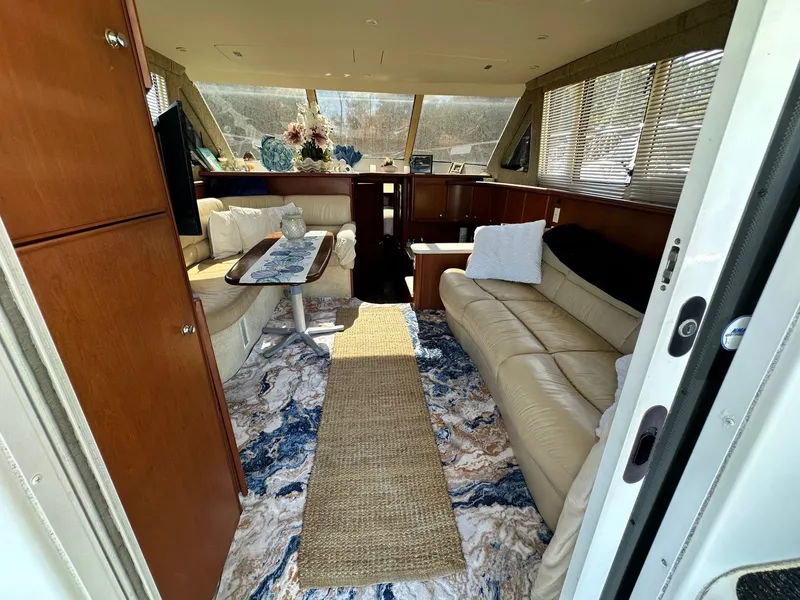 Slide: The Image of Interior of 2004 Silverton 38 Convertible yacht with luxurious seating and decor. - 33