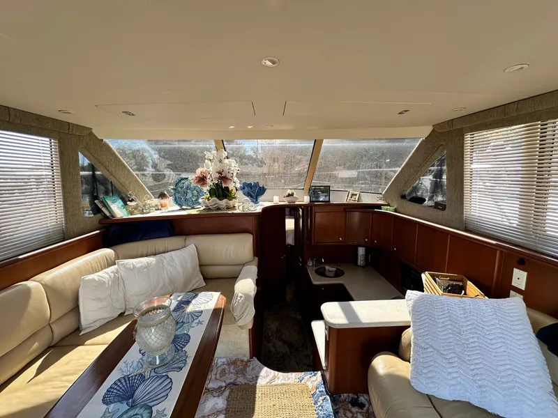 Slide: The Image of Interior of 2004 Silverton 38 Convertible yacht with cozy seating and decorative accents. - 37