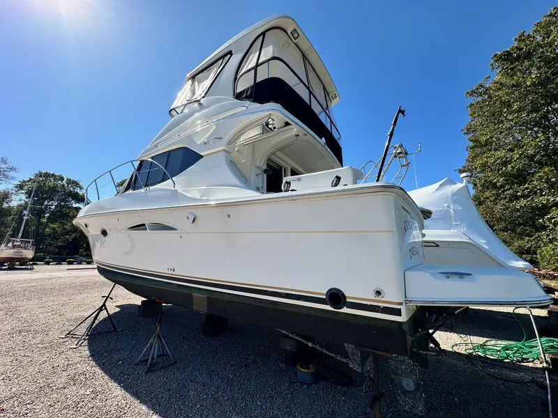 Slide: The Image of 2004 Silverton 38 Convertible yacht on dry dock under clear blue sky. - 4