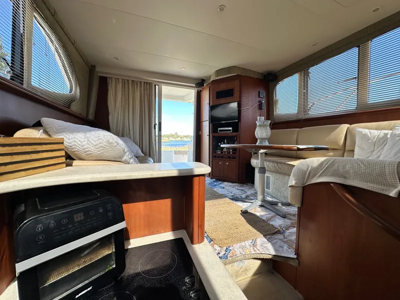 Slide: The Image of Interior of 2004 Silverton 38 Convertible yacht with cozy seating and modern amenities. - 42