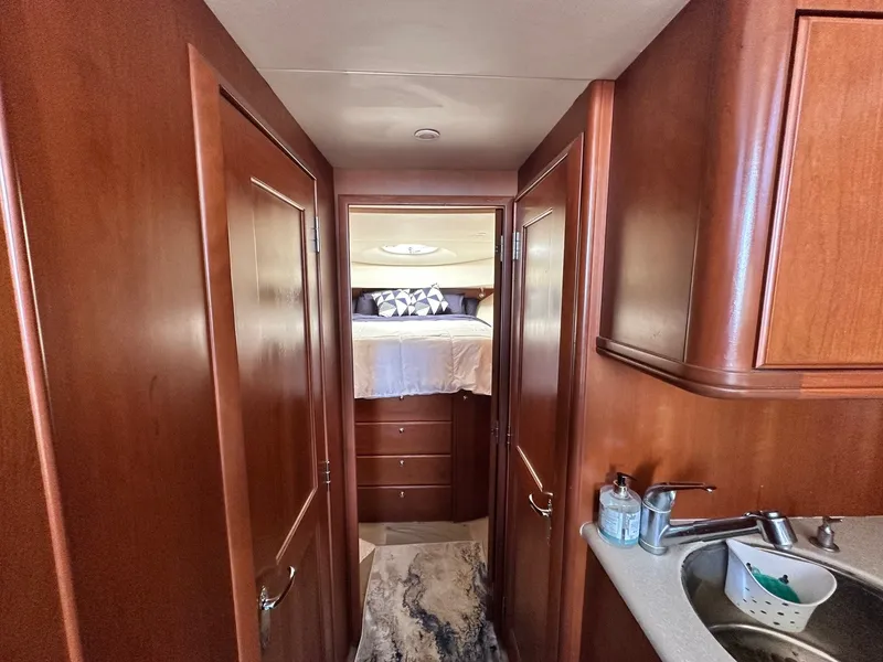 Slide: The Image of 2004 Silverton 38 Convertible yacht interior with wood cabinetry and cozy bedroom. - 47