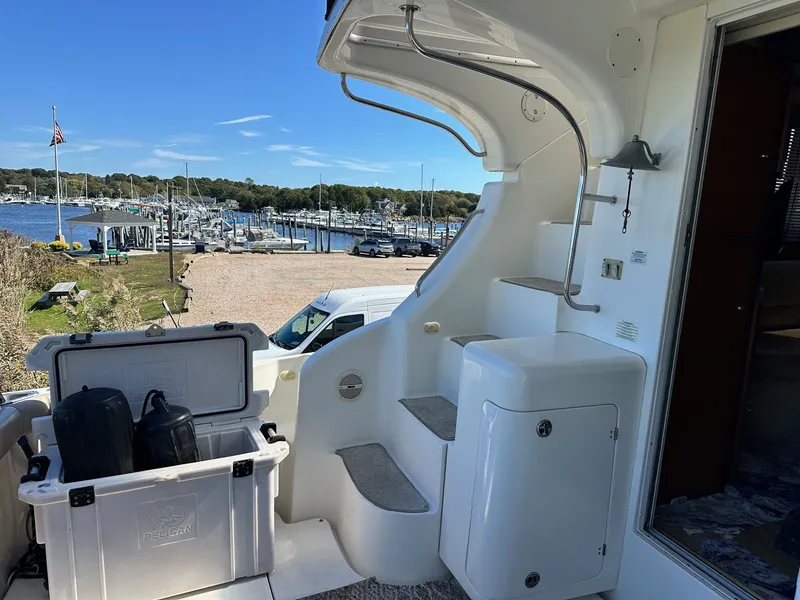 Slide: The Image of 2004 Silverton 38 Convertible yacht interior with marina view and storage compartment. - 5