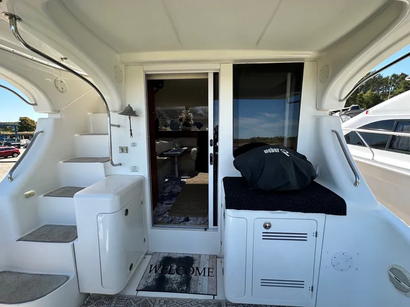 Slide: The Image of 2004 Silverton 38 Convertible yacht interior with stairs, welcome mat, and sliding glass door. - 6