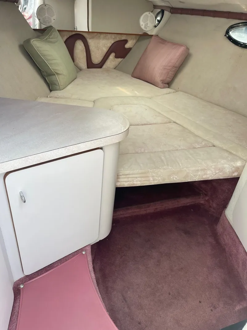 Slide: The Image of Interior of 1992 Regal Ventura boat with cushioned seating and storage. - 10