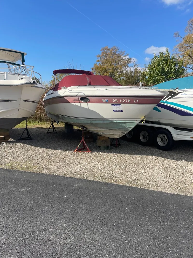 Slide: The Image of 1992 Regal Ventura boat on trailer, parked outdoors under clear blue sky. - 3