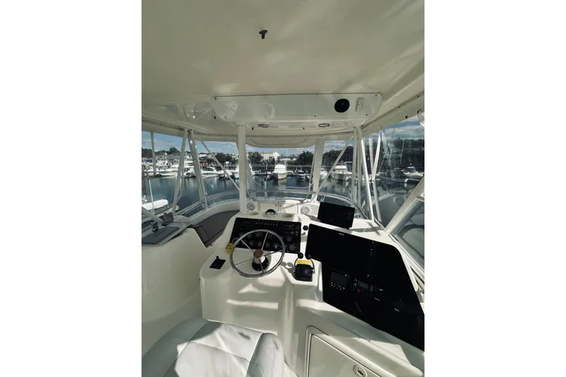 Slide: The Image of Interior view of 2000 Riviera 40 yacht cockpit with marina background. - 11