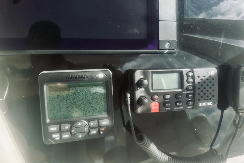 Slide: The Image of Control panel of a 2000 Riviera 40 boat with navigation screens and equipment. - 24