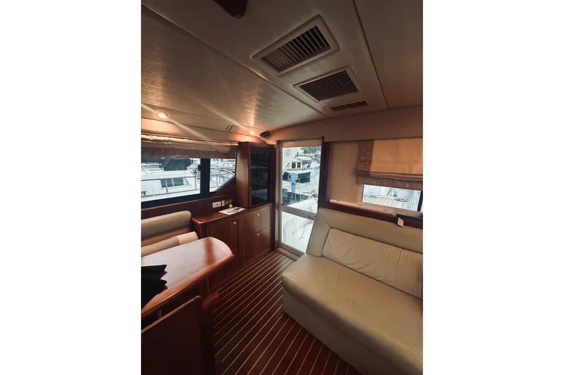 Slide: The Image of Interior of 2000 Riviera 40 yacht with elegant wood finish and seating area. - 28
