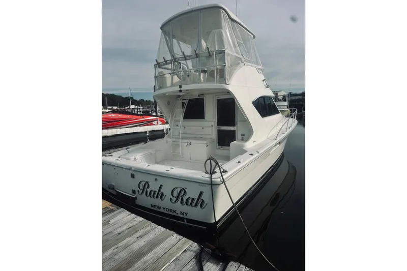 Slide: The Image of 2000 Riviera 40 yacht docked at marina under clear blue sky. - 3