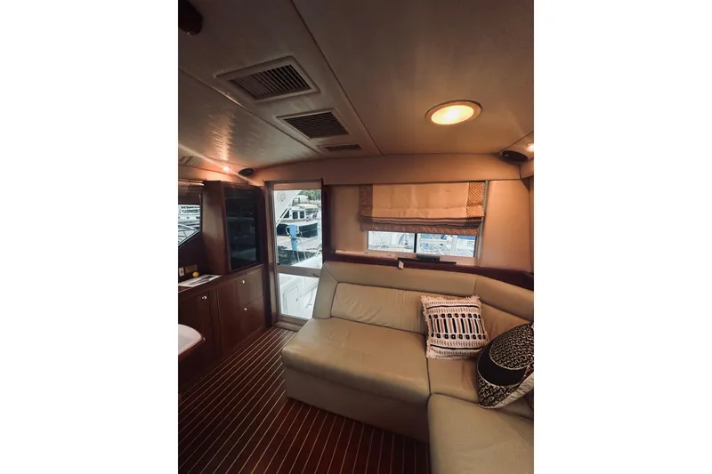 Slide: The Image of Interior of 2000 Riviera 40 yacht with wooden cabinetry and seating area. - 30