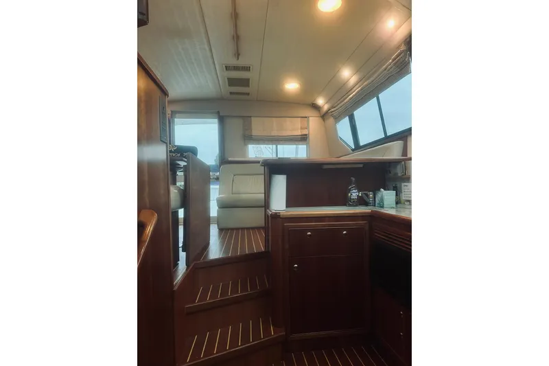 Slide: The Image of Interior of 2000 Riviera 40 yacht with elegant wood finish and modern amenities. - 31