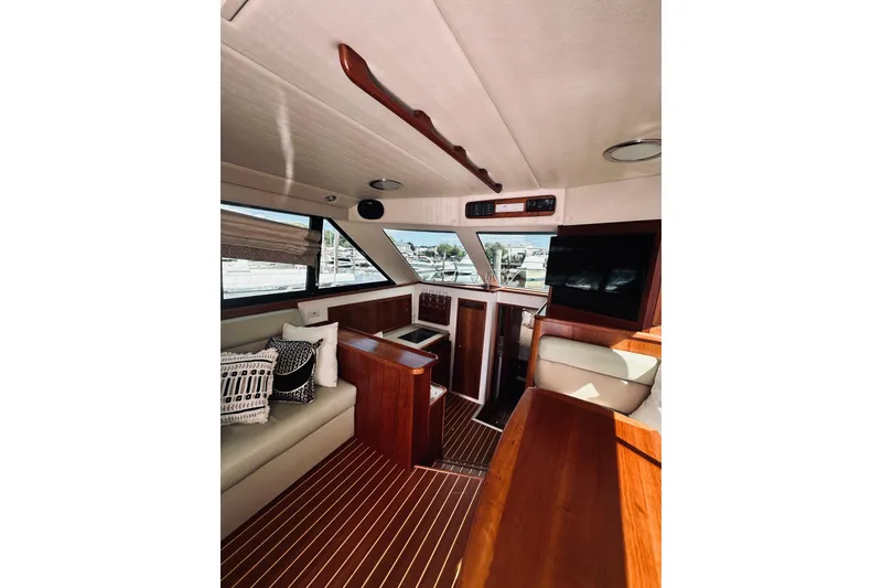 Slide: The Image of Luxurious interior of a 2000 Riviera 40 yacht with wooden finishes and plush seating. - 32