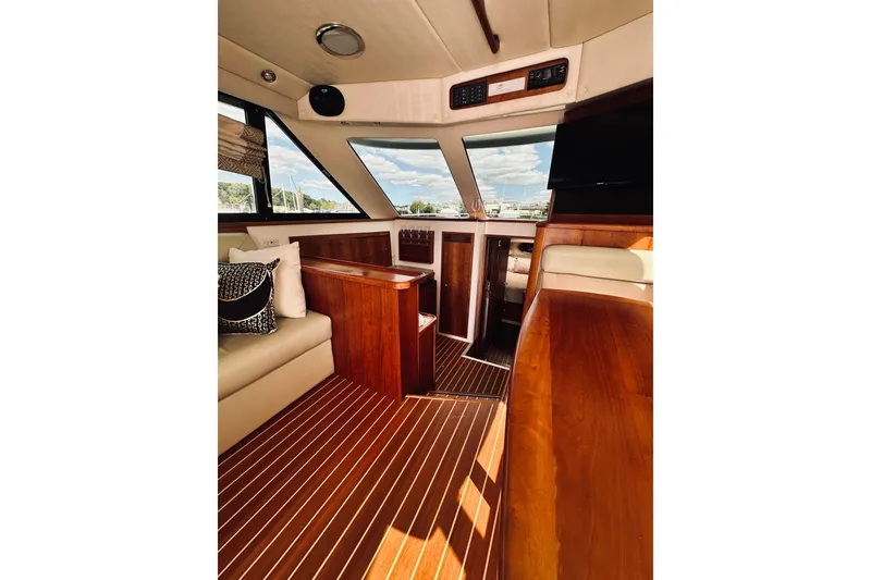 Slide: The Image of Luxurious interior of a 2000 Riviera 40 yacht with wood finishes and seating area. - 33